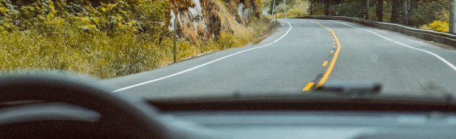 Driving on a road through the woods