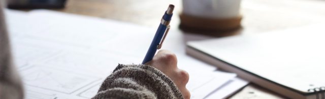 A student writing in a notebook