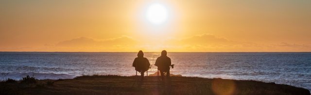 A couple enjoying retirement by the beach