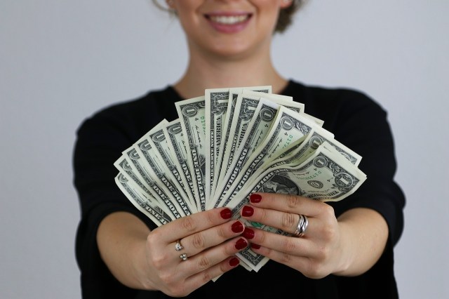 woman holding u.s. dollar bills