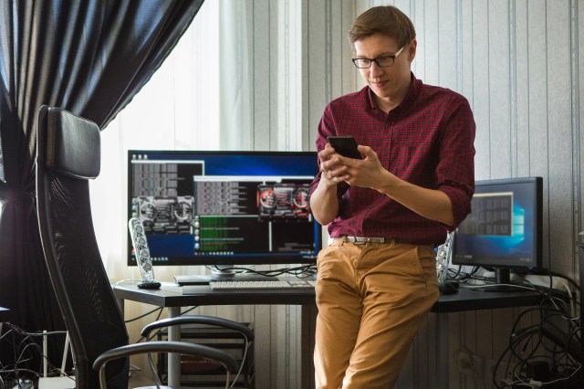 Man standing in front of computers crypto mining