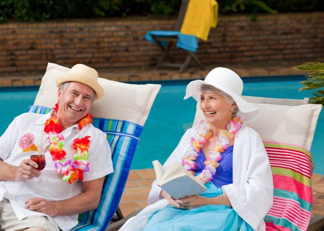 Older couple sitting in beach chairs in a beach resort or hotel