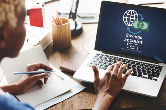 Woman on laptop logging in to savings account